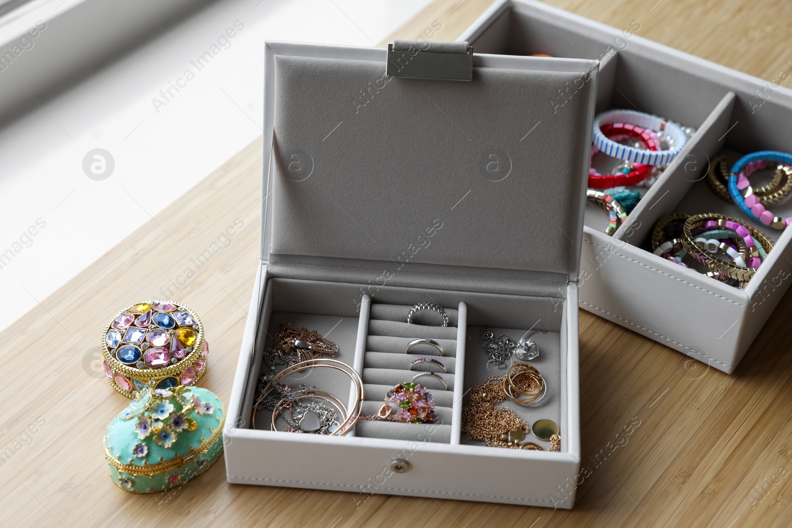 Photo of Jewelry boxes with many different accessories on wooden table