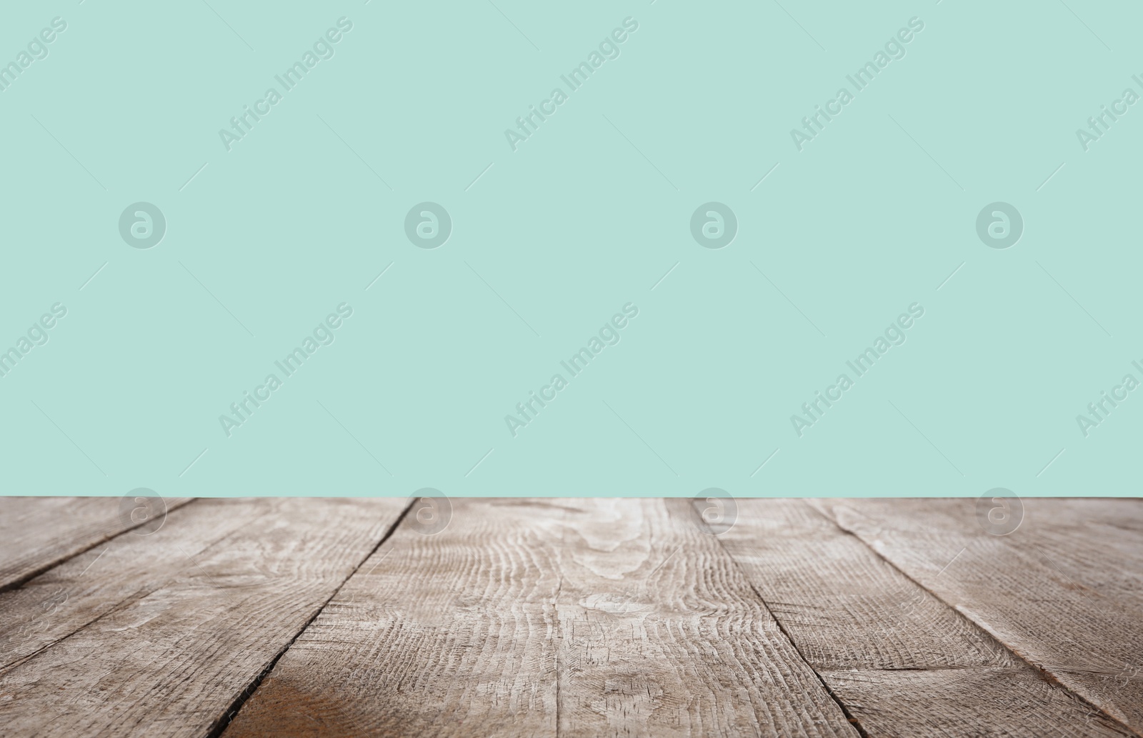 Image of Empty wooden surface on mint background. Mockup for design