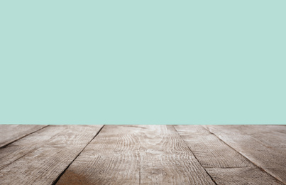 Empty wooden surface on mint background. Mockup for design