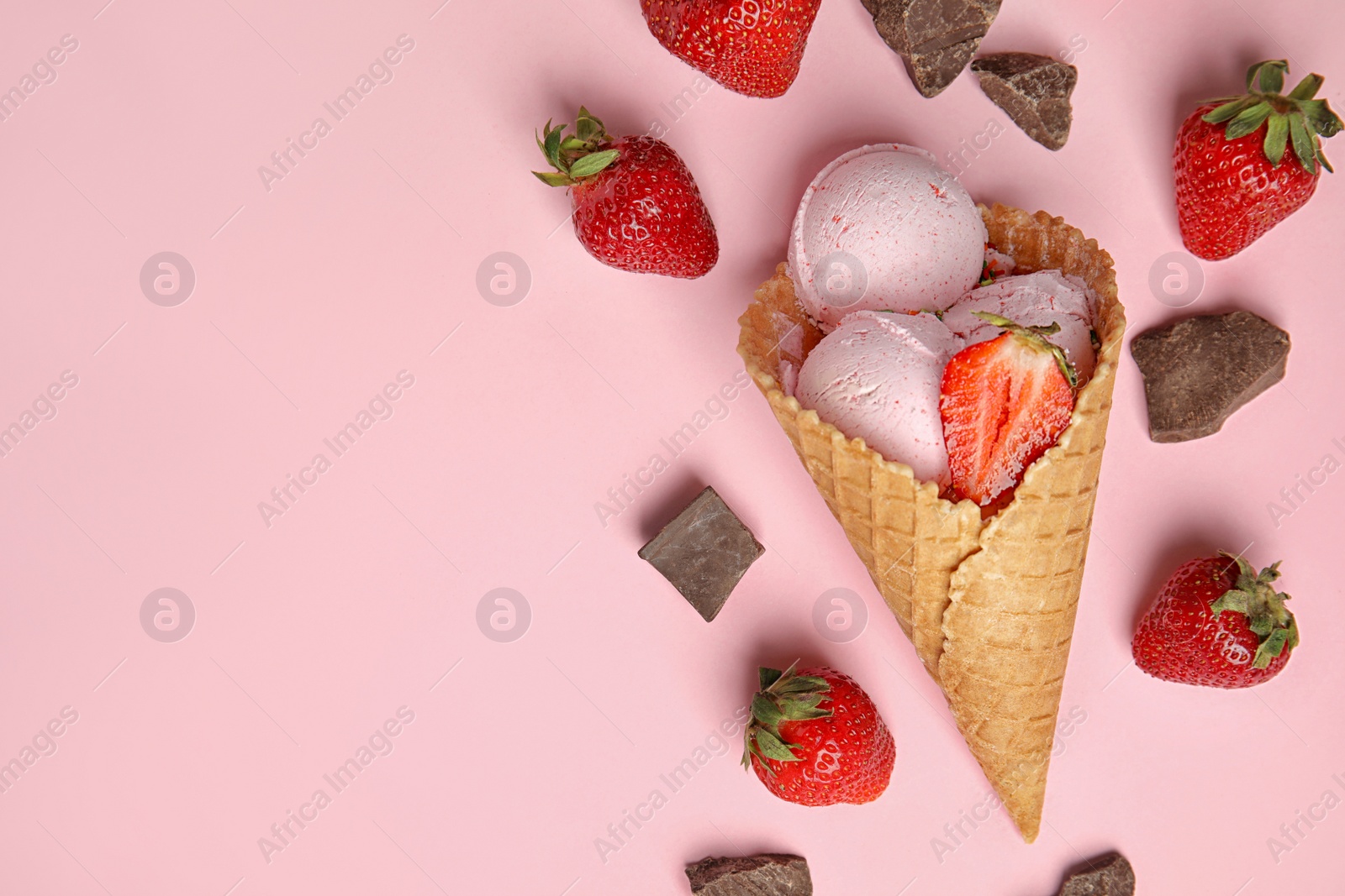 Photo of Flat lay composition with delicious ice cream in waffle cone on color background, space for text