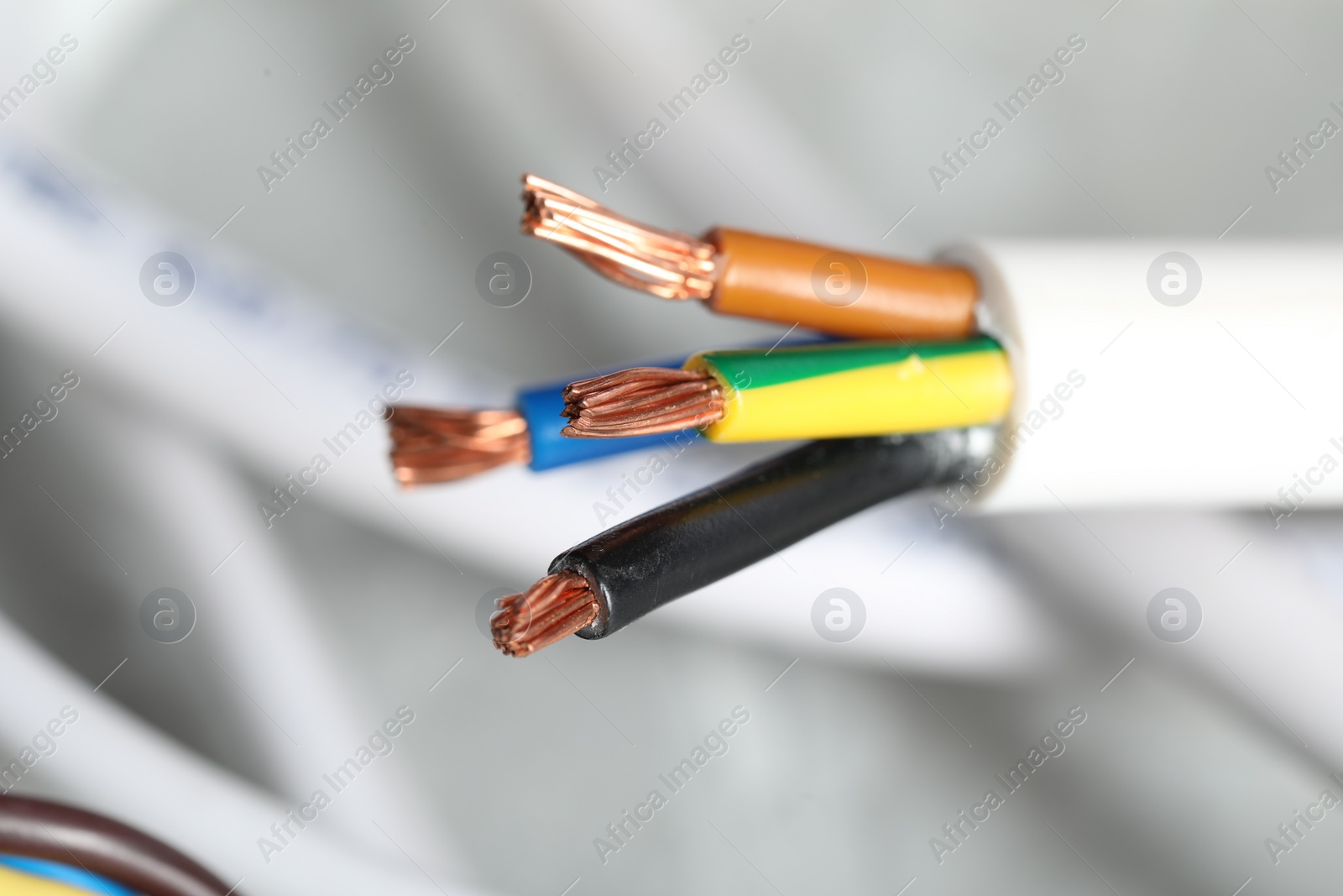 Photo of Colorful electrical wire on blurred background, closeup