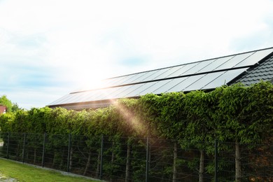 Photo of Solar panels installed on house roof outdoors. Alternative energy source