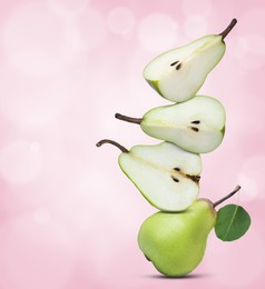 Image of Cut and whole fresh ripe pears on pink gradient background, space for text