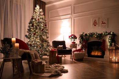 Stylish room interior with fireplace and beautiful Christmas tree