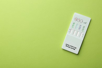Photo of Multi-drug screen test on light green background, top view. Space for text