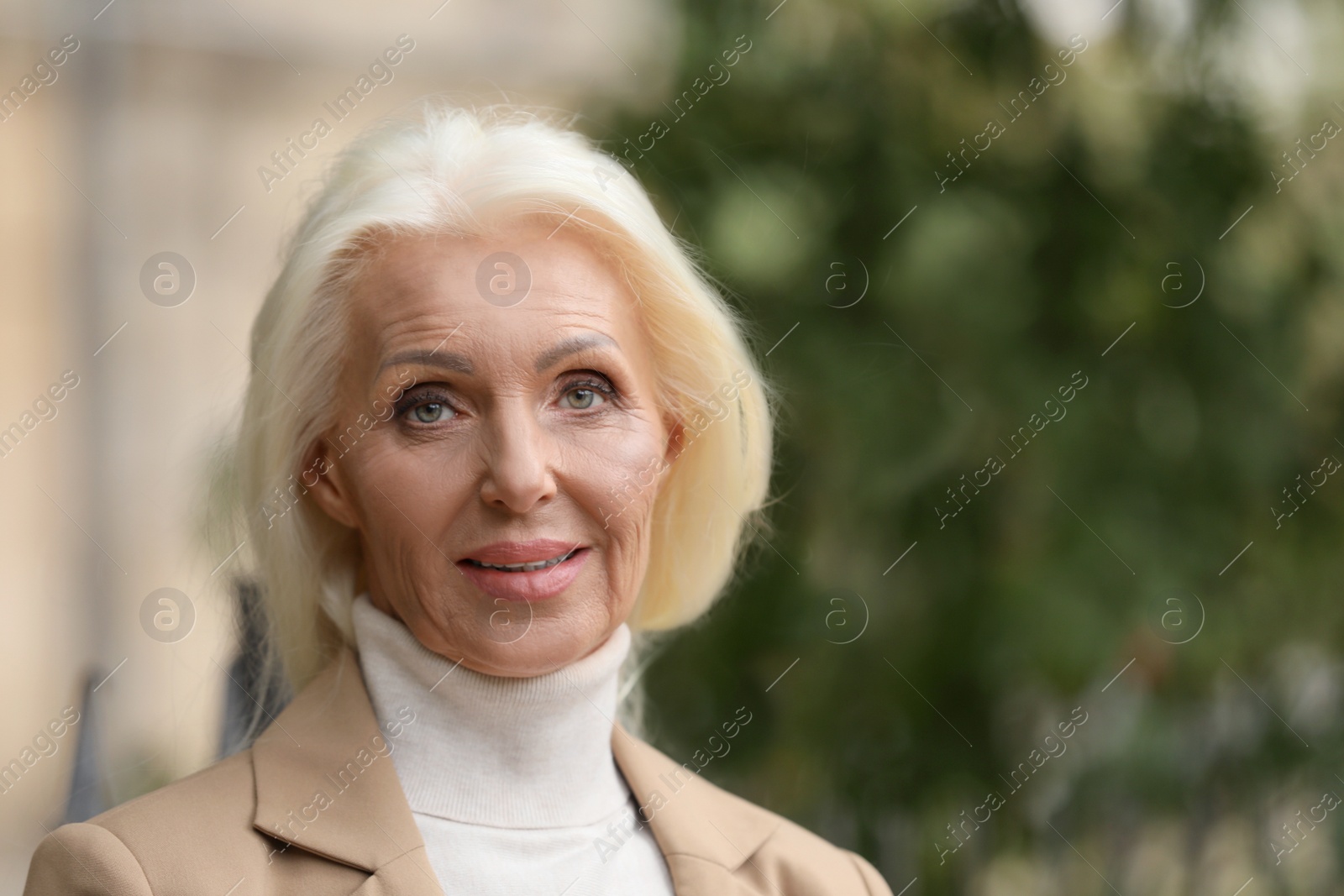 Photo of Portrait of elegant mature woman outdoors. Space for text