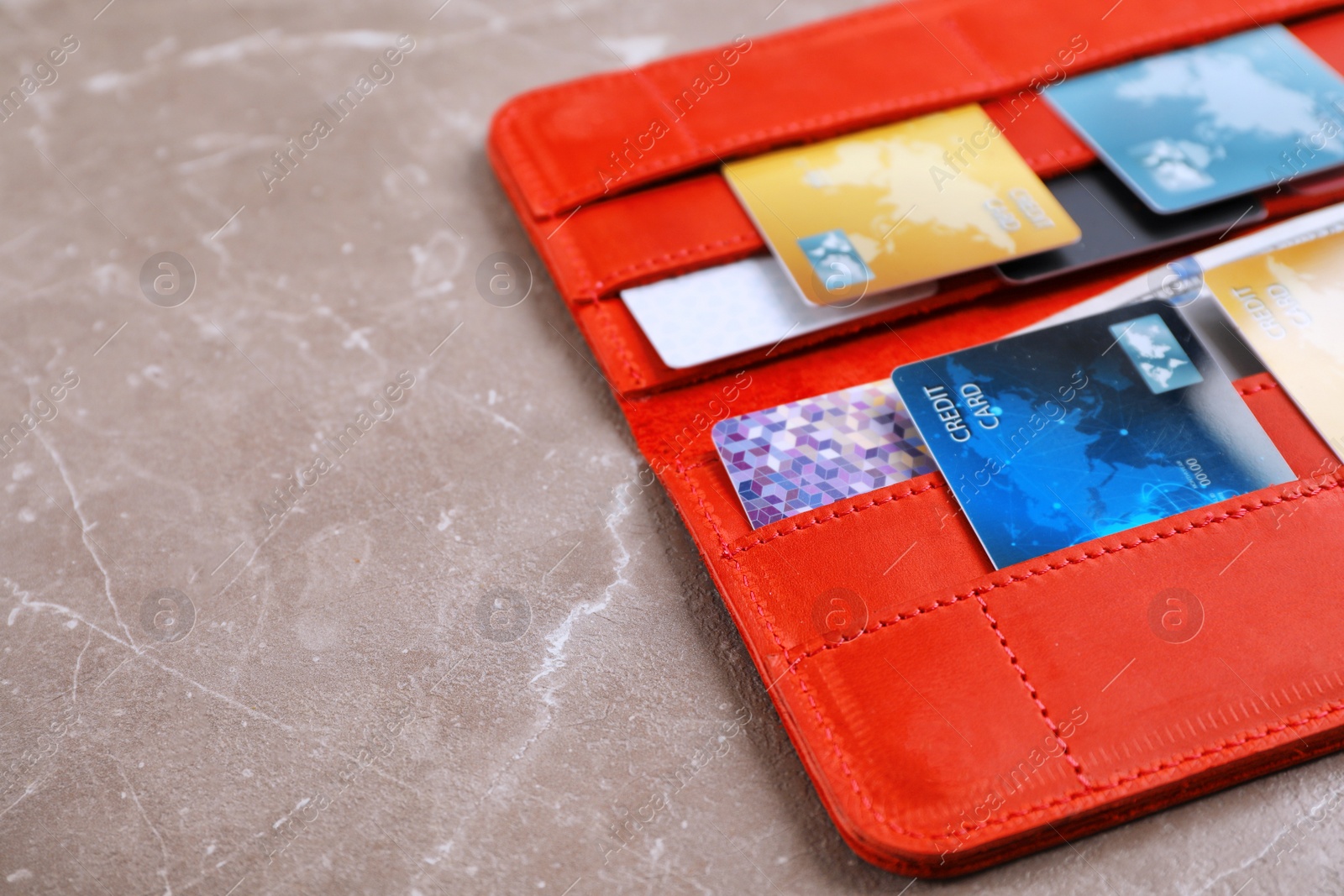 Photo of Red wallet with credit cards on table