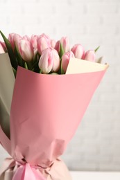 Beautiful bouquet of fresh pink tulips on blurred background, closeup