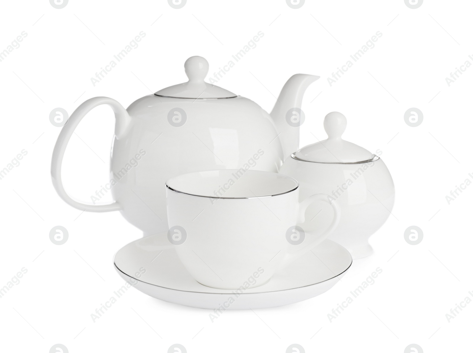 Photo of Ceramic cup with saucer, teapot and sugar bowl on white background