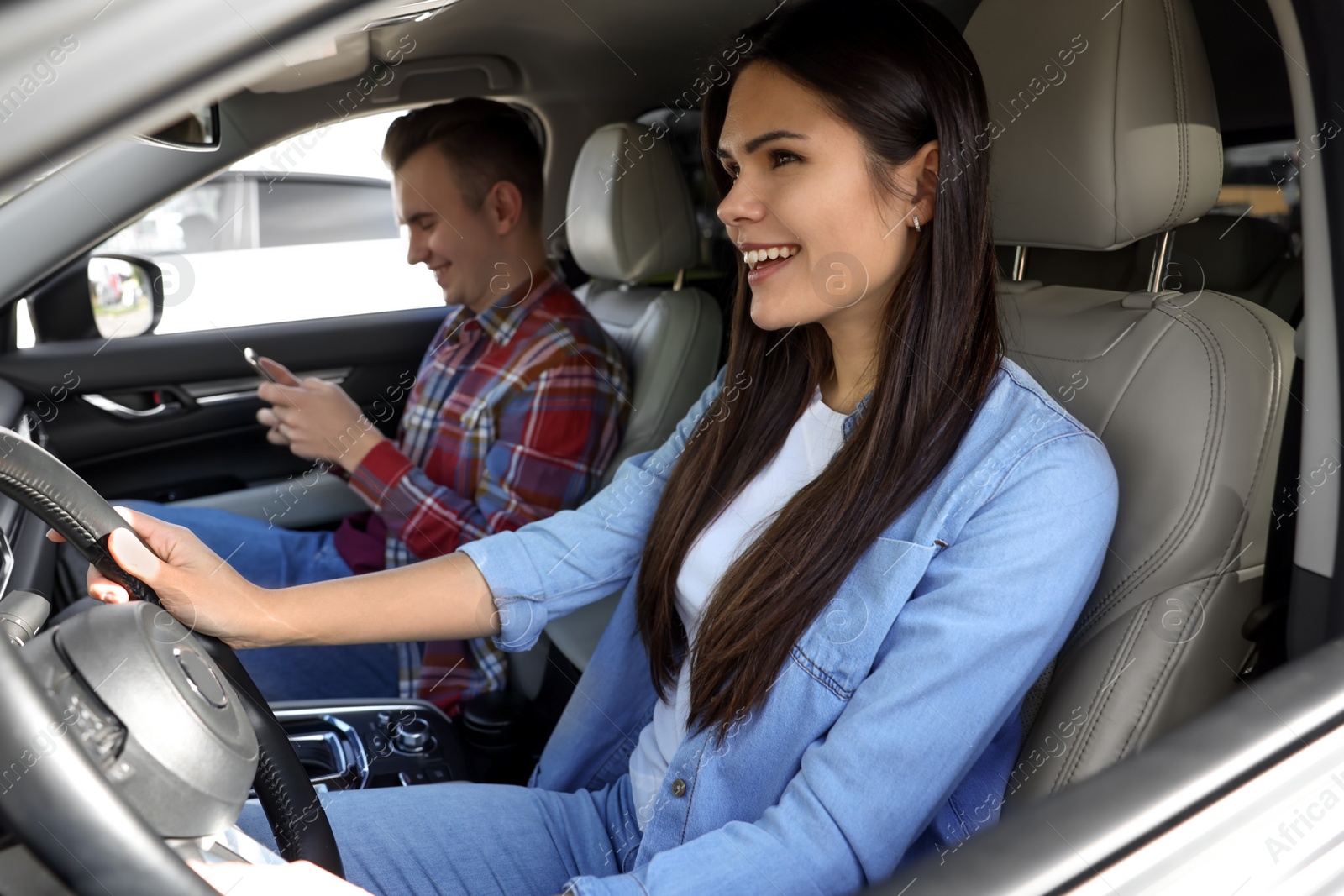 Photo of Happy young couple travelling together by car