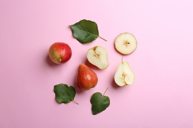 Ripe juicy pears on pink background, flat lay