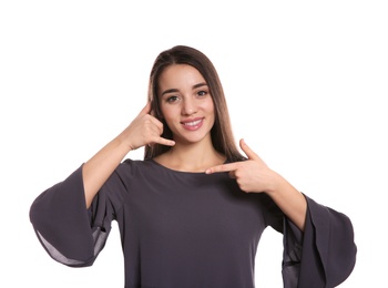 Photo of Woman showing CALL ME gesture in sign language on white background