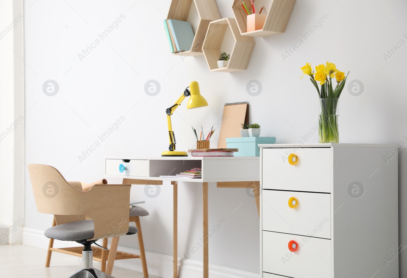 Photo of Comfortable workplace with wooden furniture and lamp