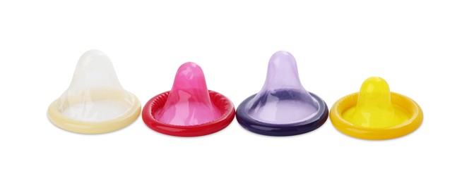 Photo of Unpacked condoms on white background. Safe sex