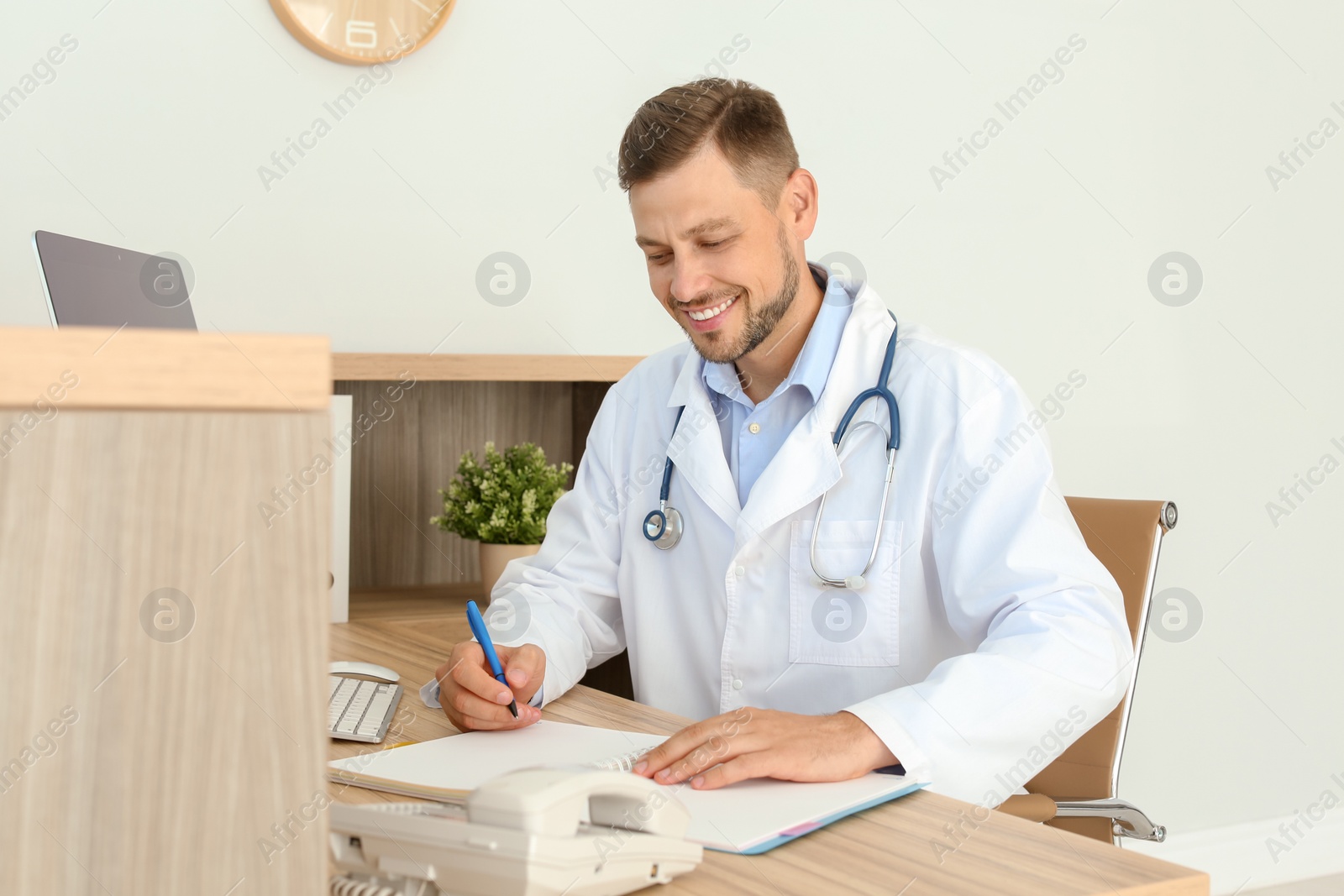 Photo of Male medical assistant at workplace in clinic. Health care service