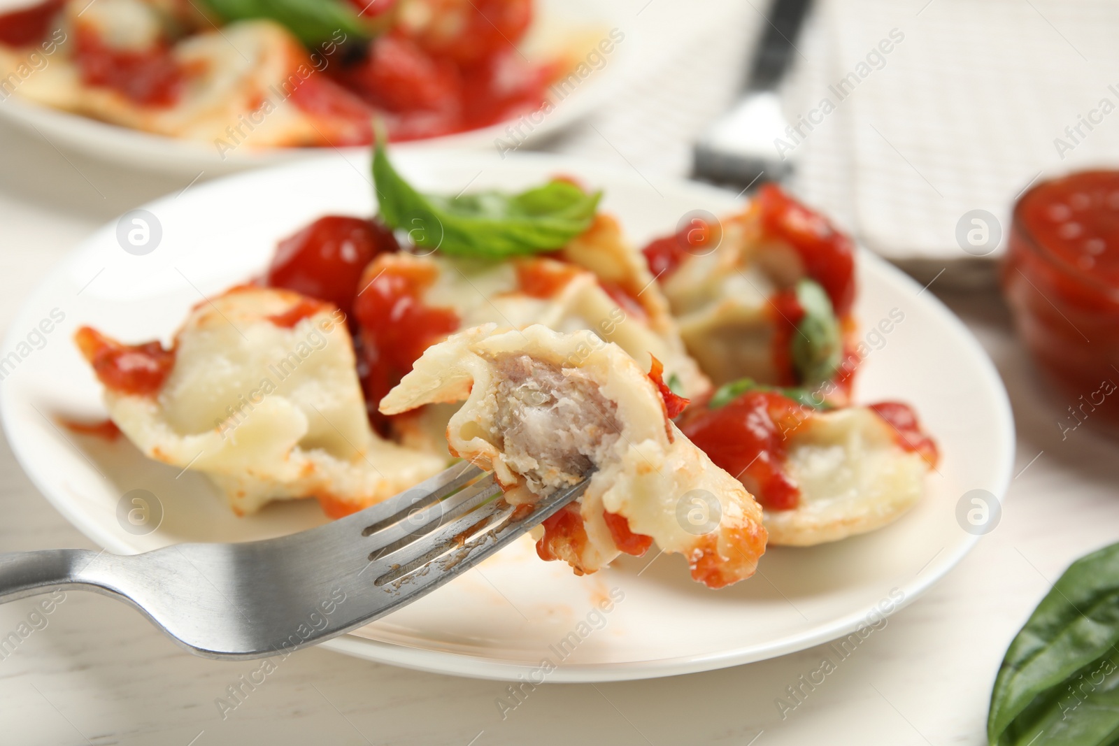 Photo of Eating traditional ravioli with tasty filling, closeup