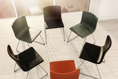 Chairs prepared for group therapy session in office. Meeting room interior