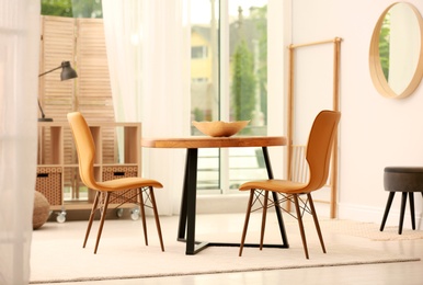 Photo of Modern dining room interior with table and chairs