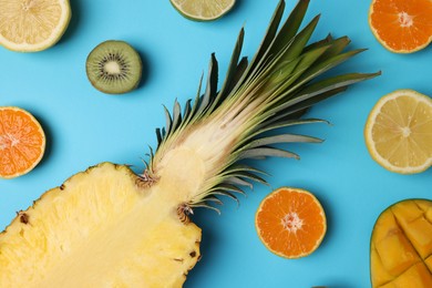 Different ripe fruits on light blue background, flat lay