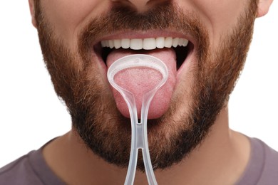 Man brushing his tongue with cleaner on white background, closeup