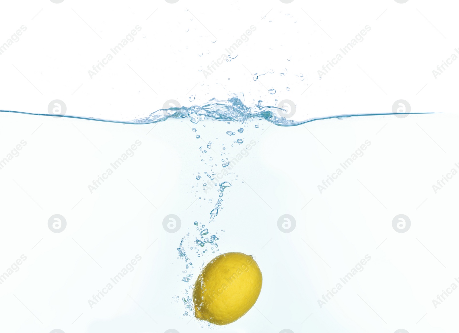 Photo of Ripe lemon falling down into clear water with splashes against white background