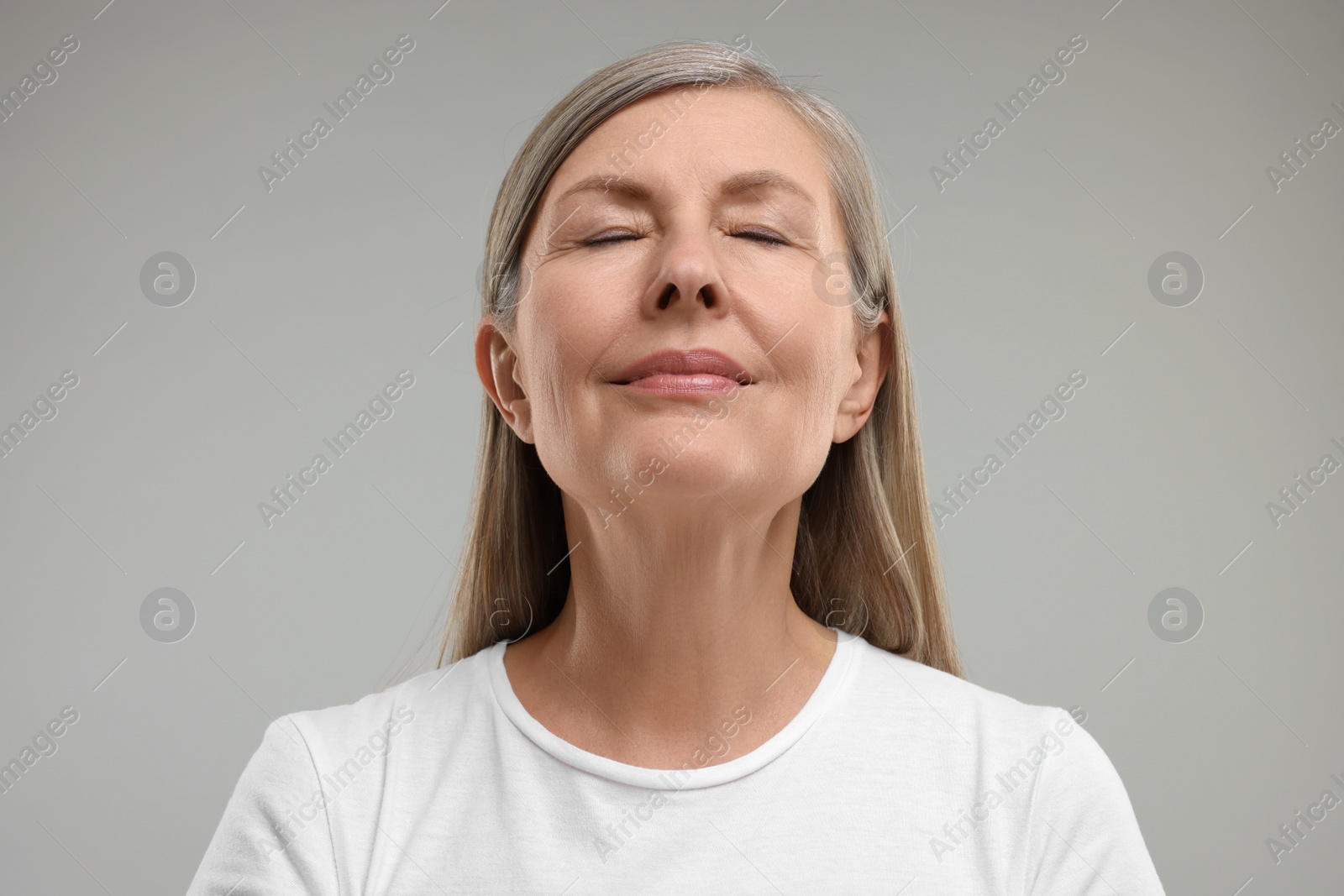 Photo of Beautiful woman with healthy skin on grey background