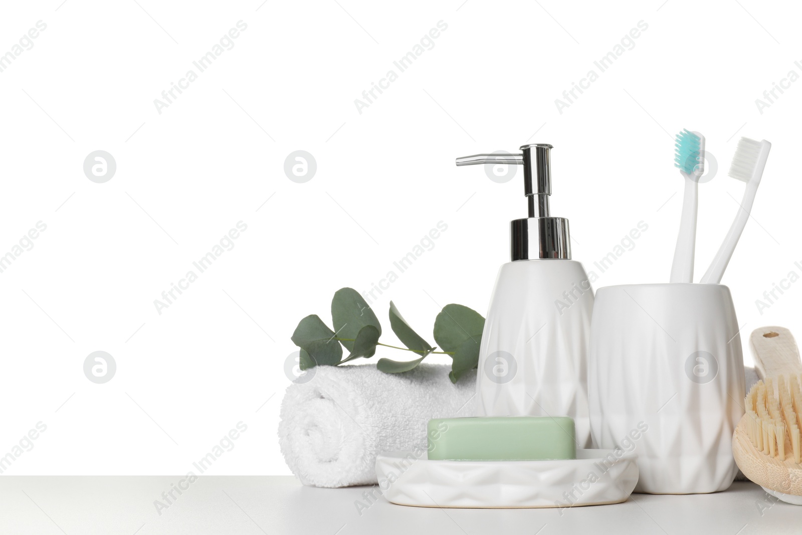 Photo of Bath accessories. Different personal care products and eucalyptus branch on table against white background. Space for text