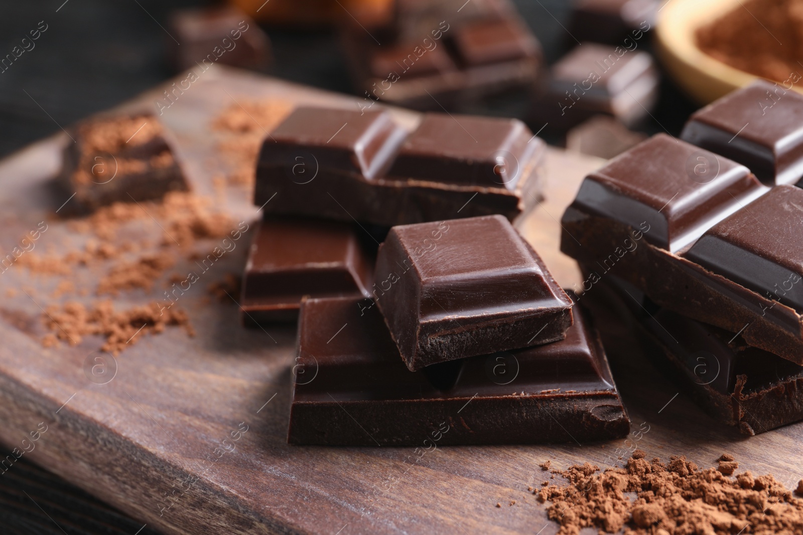 Photo of Pieces of black chocolate on wooden board