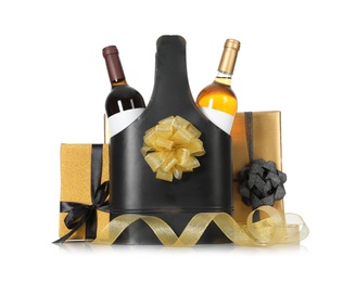 Festive package with bottles of wine and gift boxes on white background