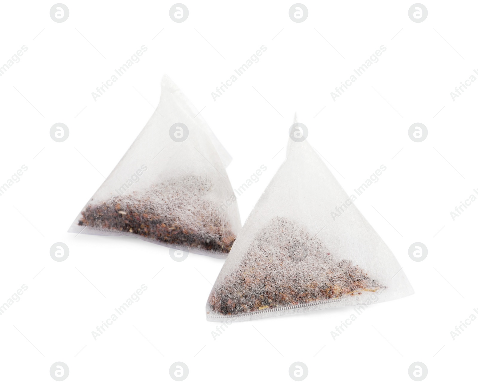 Photo of New pyramid tea bags on white background