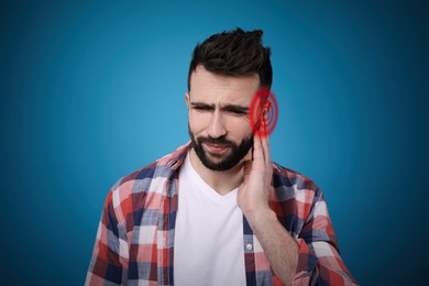 Image of Man suffering from ear pain on blue background