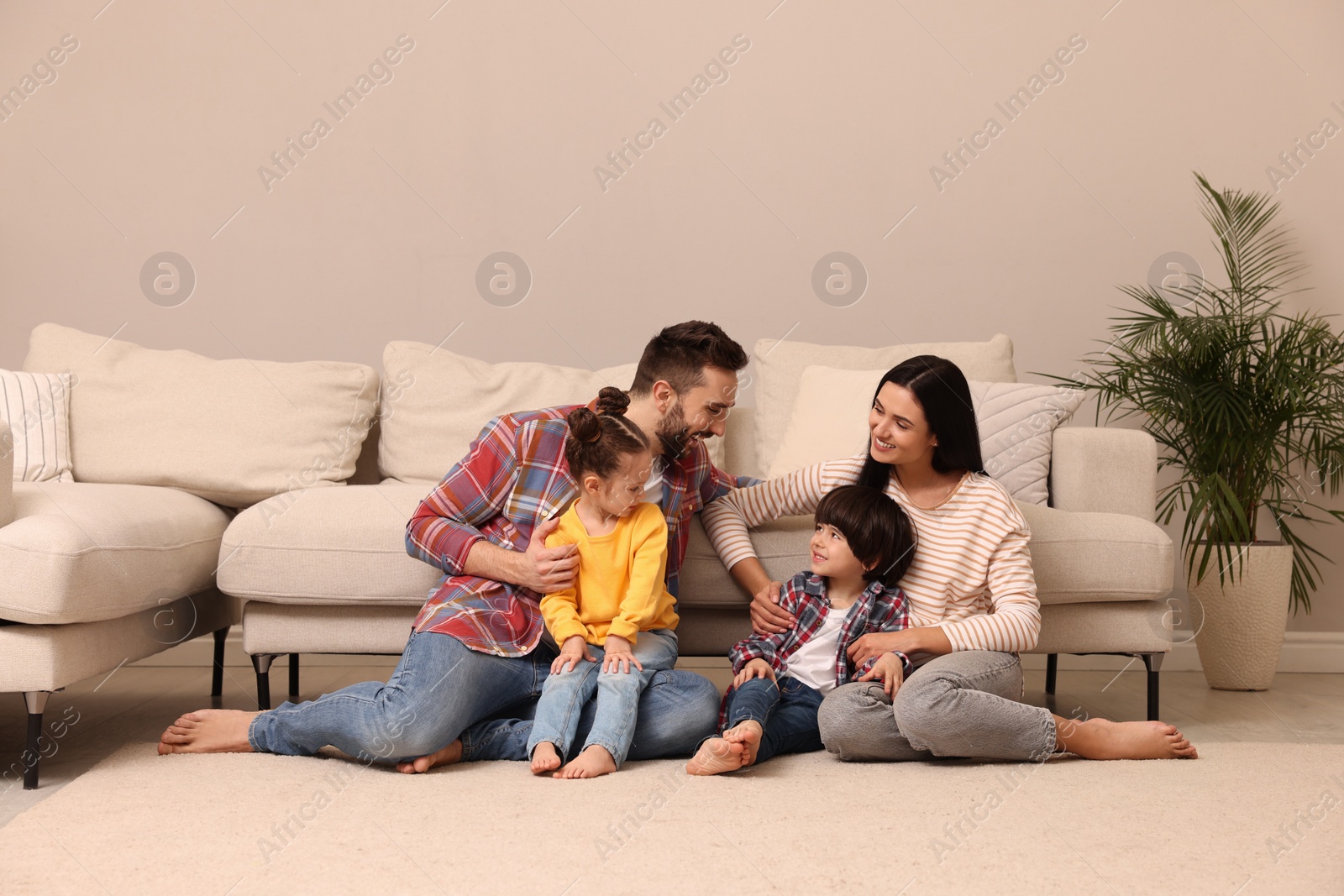 Photo of Happy family spending time together in living room