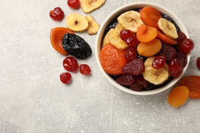 Photo of Mix of delicious dried fruits on grey table, flat lay. Space for text