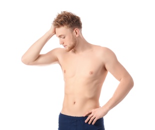 Portrait of young man with slim body on white background