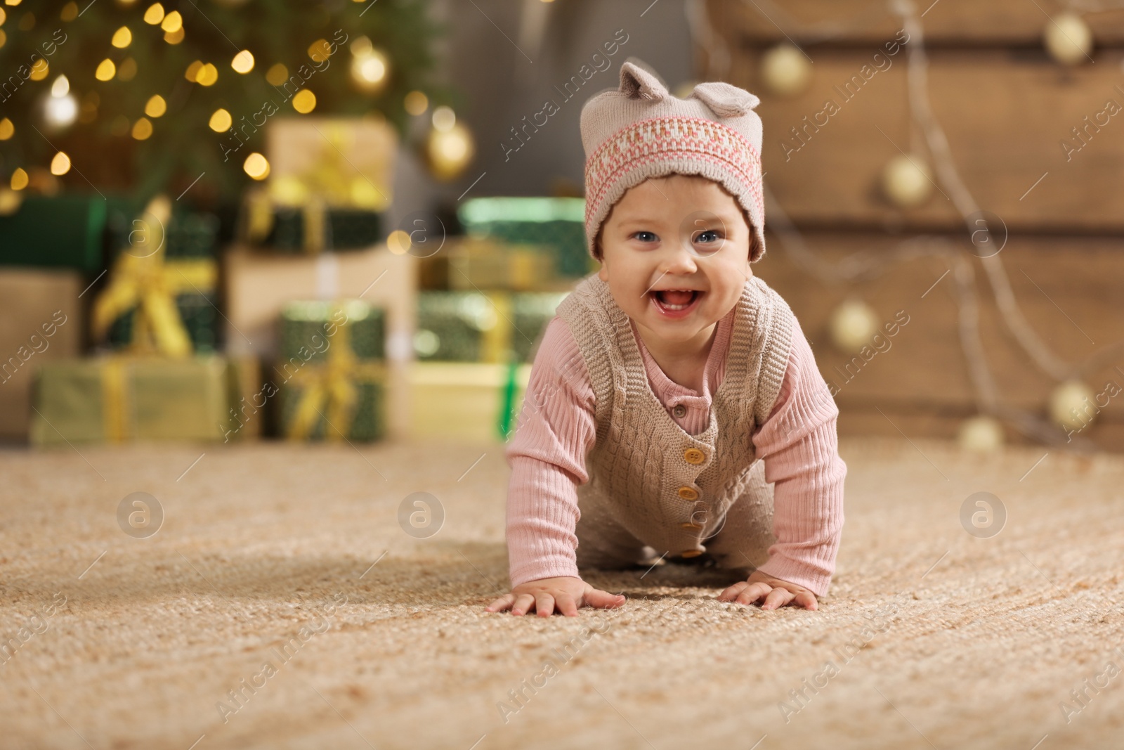 Photo of Cute little baby in room decorated for Christmas. Winter holiday