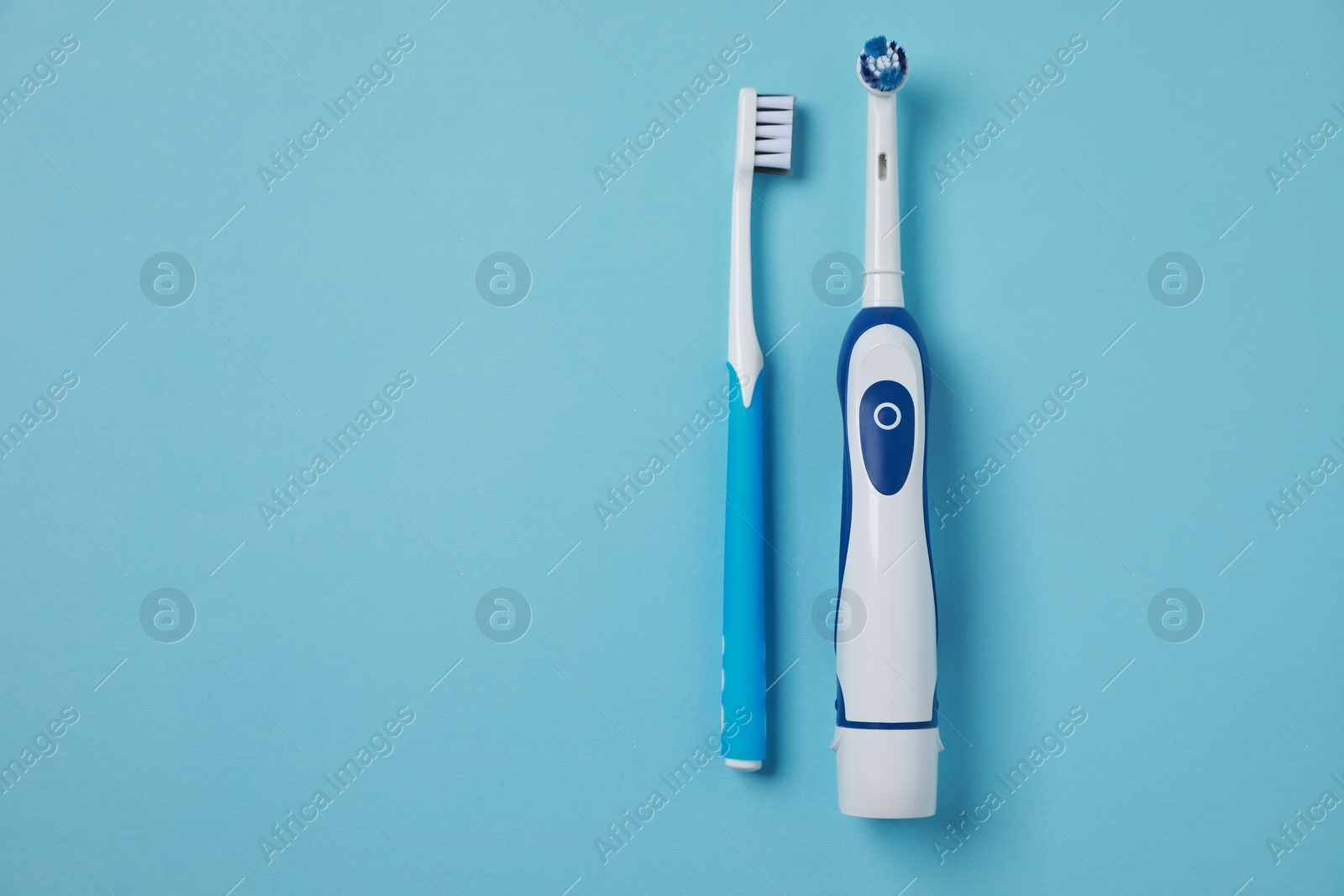 Photo of Electric and plastic toothbrushes on turquoise background, flat lay. Space for text
