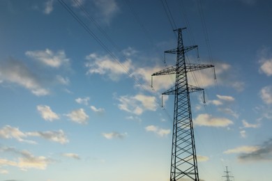 Photo of Telephone pole with cables under blue sky outdoors