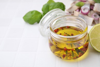 Photo of Tasty fish marinade in jar on light tiled table, closeup. Space for text