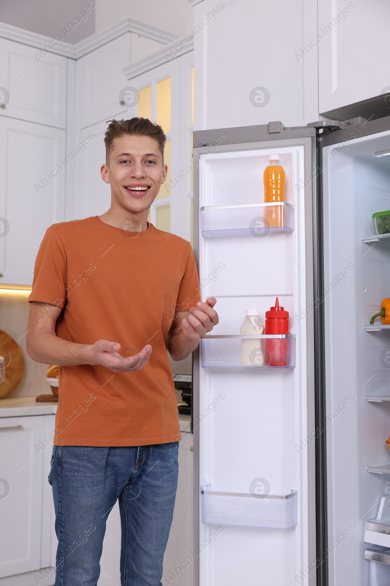 Photo of Smiling food blogger explaining something in kitchen