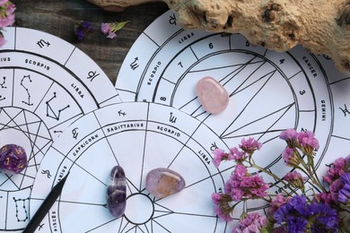 Photo of Flat lay composition with zodiac wheels and astrology dices on wooden table