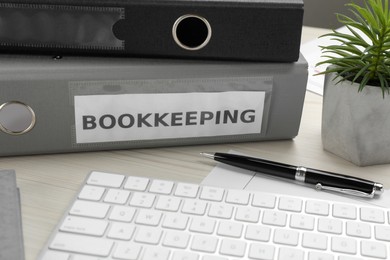 Photo of Bookkeeper's workplace with folders and documents on table