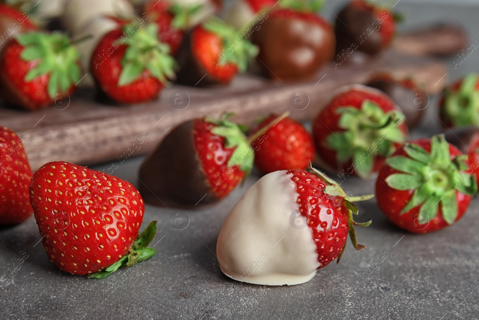 Photo of Delicious chocolate covered strawberries on table, closeup