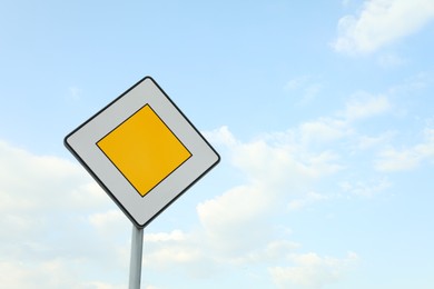 Traffic sign Priority Road against blue sky. Space for text