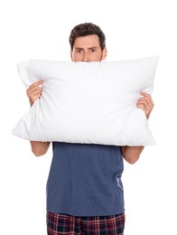 Photo of Handsome man covering mouth with soft pillow on white background