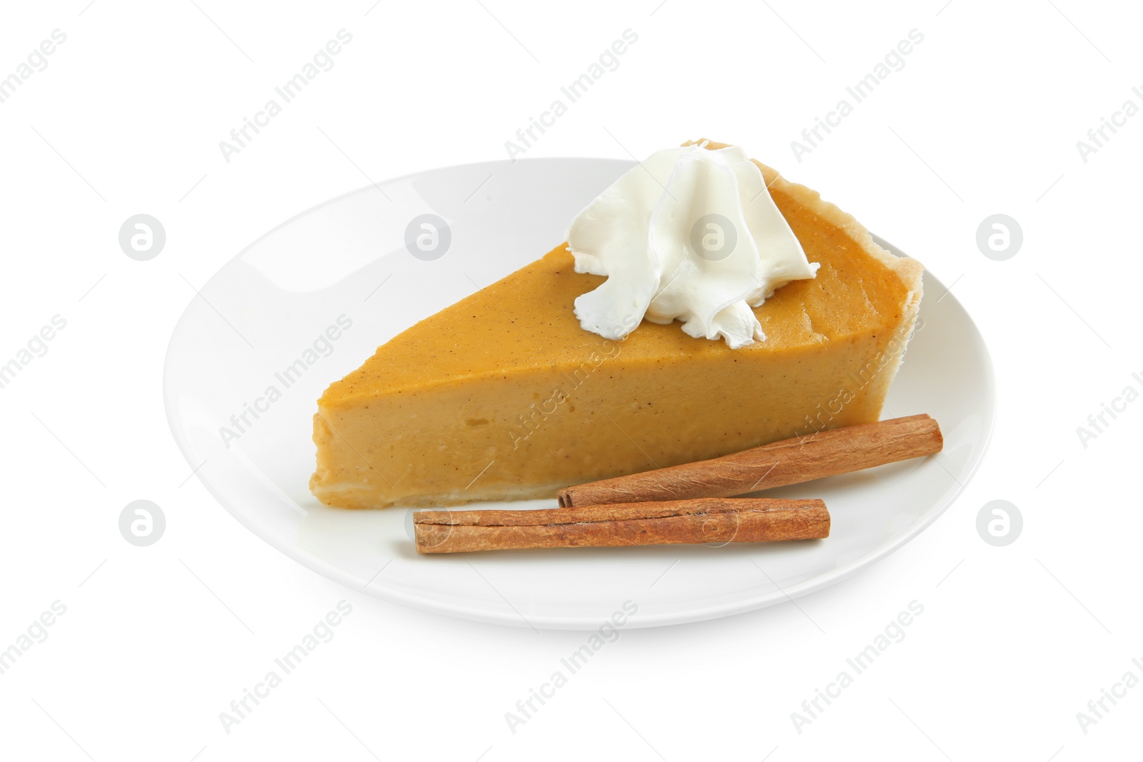 Photo of Piece of delicious pumpkin pie with whipped cream and cinnamon sticks isolated on white