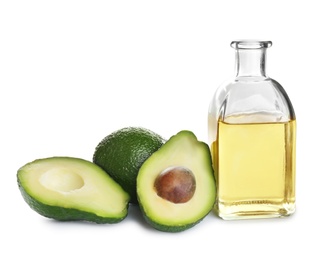 Photo of Bottle of natural oil and avocados isolated on white