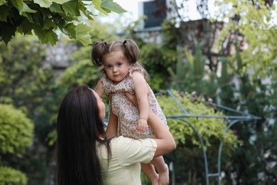 Photo of Mother with her cute daughter spending time together in park