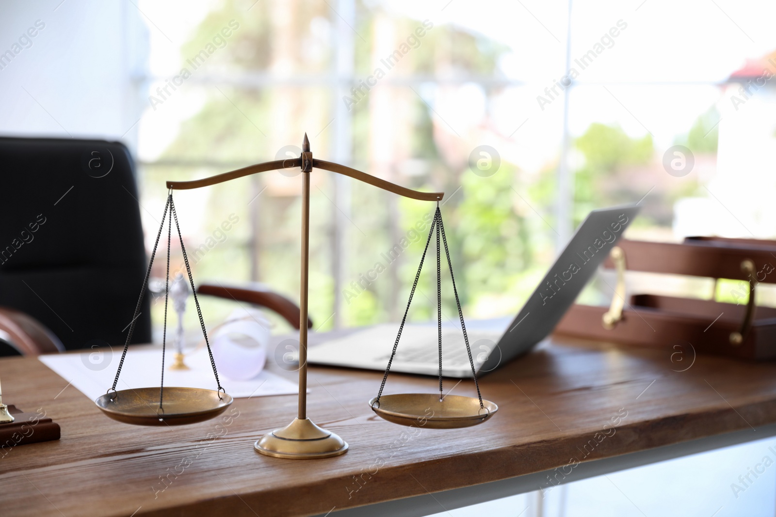 Photo of Scales of justice on desk in notary's office