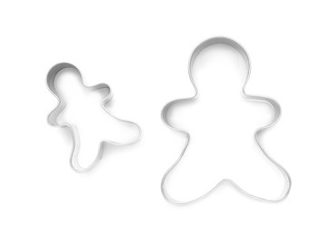 Photo of Gingerbread man cookie cutters on white background, top view