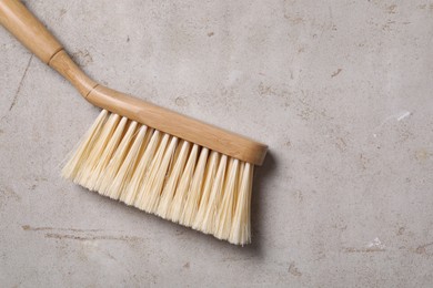 Photo of Cleaning brush on light grey table, top view. Space for text